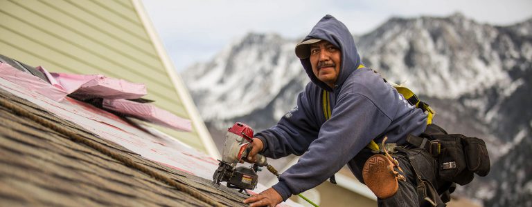 Happy worker at intermountain West contractors - Utah's roofing experts