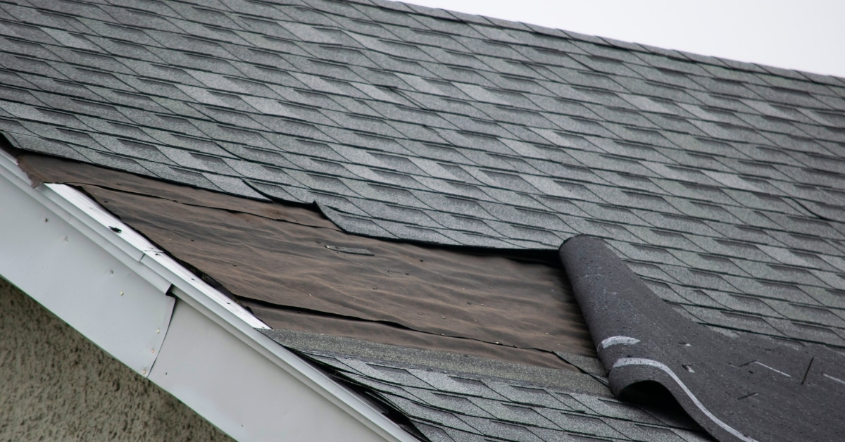 Weather-damaged roof with missing shingles in Utah