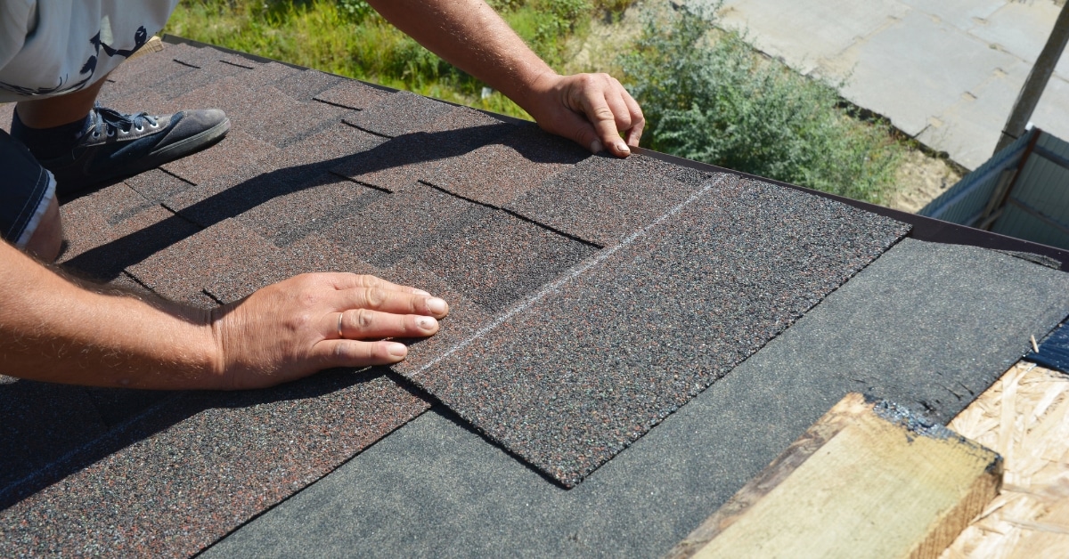 Roofer installing shingles on a residential home in Salt Lake City, Utah