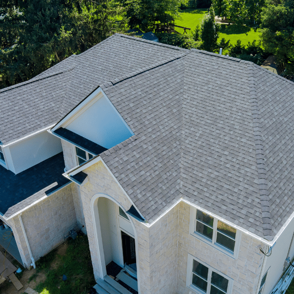 Roof inspector assessing shingles and flashing
