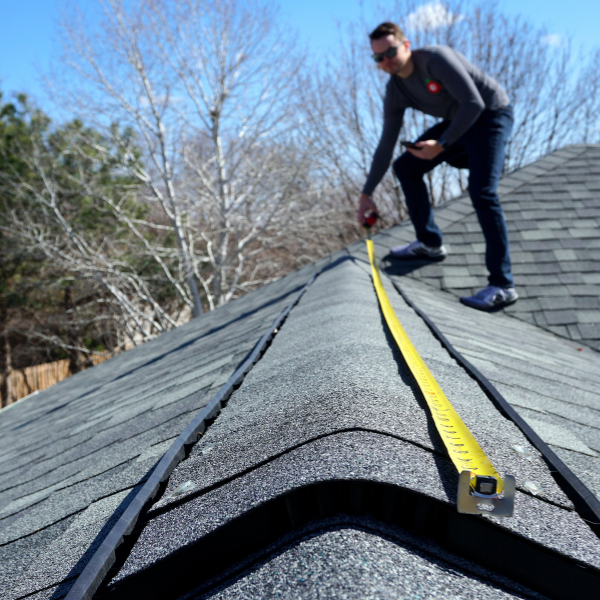 Roofing contractor inspecting a Utah home roof before replacement