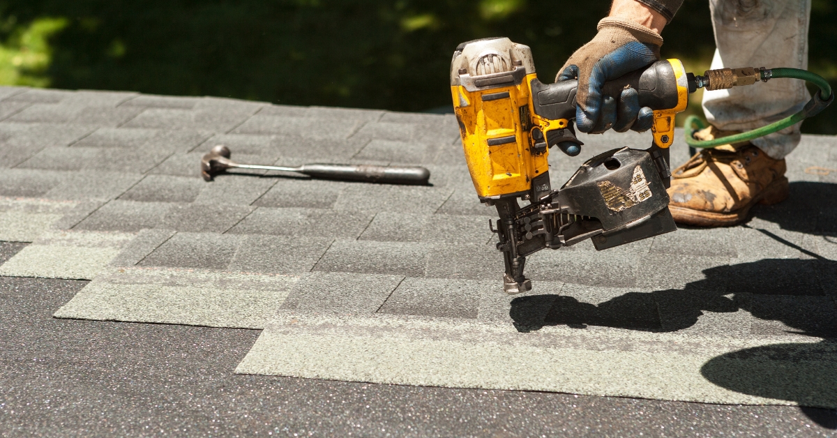 Roof replacement service in Utah with contractors installing shingles